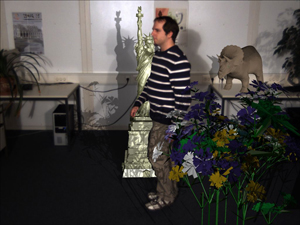 Final mixing result with shadow mapping. In this example two light sources are placed left and right of the camera. The real light sources have been simulated in the shadow mapping and shadow casting between virtual content and real dynamic content is visible. (Note the shadow on the legs of the person.)